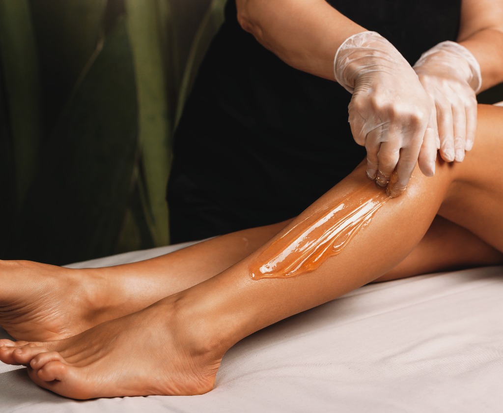 Young caucasian girl having epilation procedures with sugar at spa salon